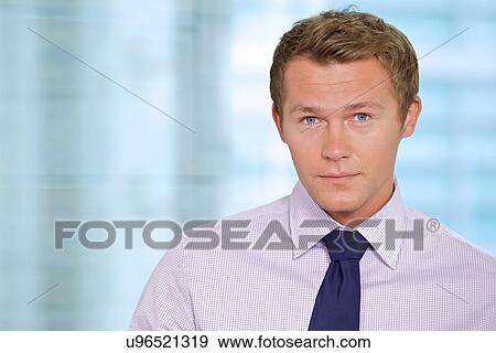 Stock Photo - Portrait of businessman at office. Fotosearch
