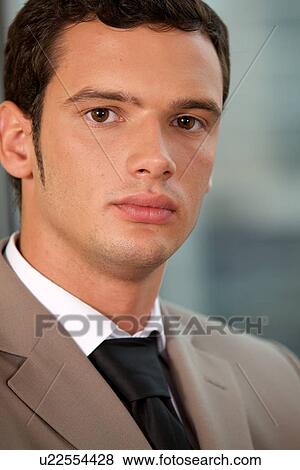 Portrait of businessman standing in office View Large Photo Image Stock Photo - Portrait of businessman standing in office. Fotosearch