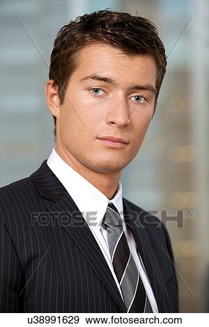 Portrait of businessman standing in office View Large Photo Image Stock Photo - Portrait of businessman standing in office. Fotosearch