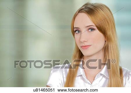 Stock Image - Portrait of businesswoman at office. Fotosearch