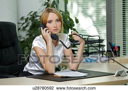 Portrait of businesswoman using phone at office View Large Photo Image Stock Image - Portrait of businesswoman using phone at office. Fotosearch