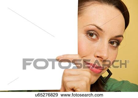 Stock Photo - Portrait of businesswoman with document at office. Fotosearch