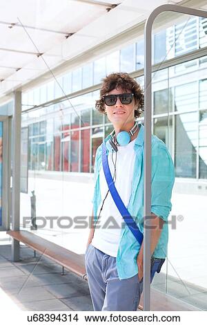 Portrait of confident man waiting at bus stop View Large Photo Image Picture - Portrait of confident man waiting at bus stop. Fotosearch