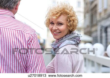Portrait of happy middle-aged woman with man outdoors View Large Photo Image Stock Image - Portrait of happy middle-aged woman with man outdoors. Fotosearch