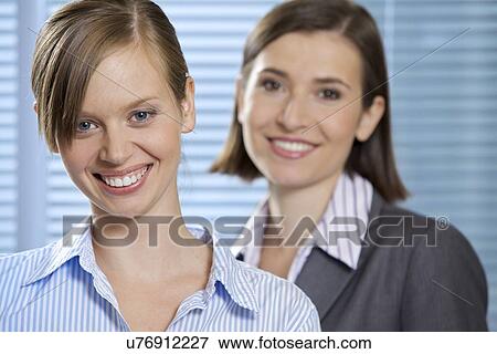 Portrait of smiling businesswomen in office View Large Photo Image Stock Photo - Portrait of smiling businesswomen in office. Fotosearch