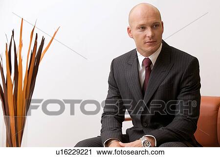 Stock Image - Portrait of young caucasian businessman in office. Fotosearch