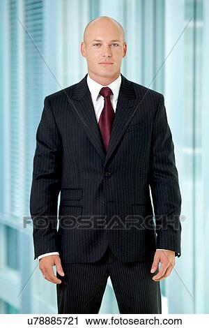 Stock Image - Portrait of young caucasian businessman in office. Fotosearch