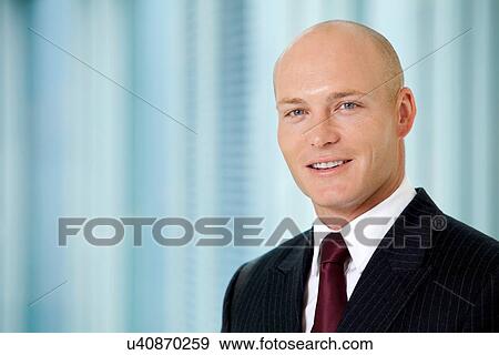 Stock Photo - Portrait of young caucasian businessman in office. Fotosearch