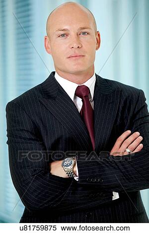 Stock Photography - Portrait of young caucasian businessman in office. Fotosearch