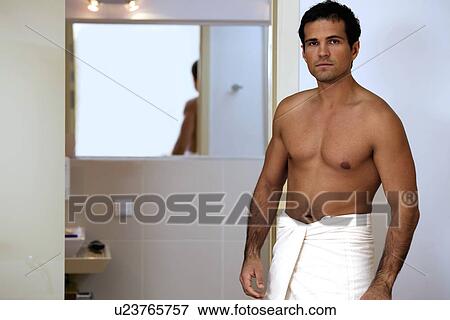 Stock Photo - Portrait of young man wrapped in towel. Fotosearch