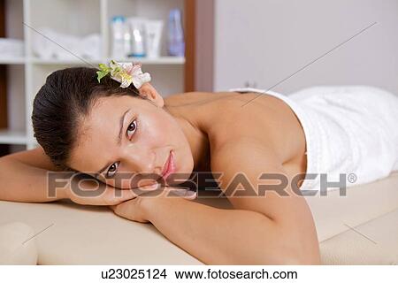 Portrait of young woman relaxing on massage table View Large Photo Image Picture - Portrait of young woman relaxing on massage table. Fotosearch