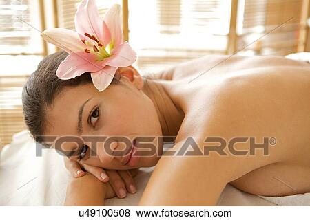 Portrait of young woman relaxing on massage table View Large Photo Image Stock Photo - Portrait of young woman relaxing on massage table. Fotosearch
