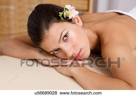 Portrait of young woman relaxing on massage table View Large Photo Image Stock Photo - Portrait of young woman relaxing on massage table. Fotosearch