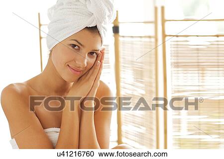 Portrait of young woman wrapped in towel with hands clasped View Large Photo Image Stock Image - Portrait of young woman wrapped in towel with hands clasped. Fotosearch
