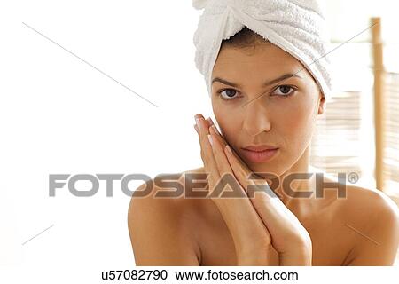 Portrait of young woman wrapped in towel with hands clasped View Large Photo Image Stock Image - Portrait of young woman wrapped in towel with hands clasped. Fotosearch