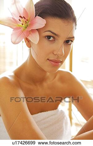 Stock Photo - Portrait of young woman wrapped in towel. Fotosearch
