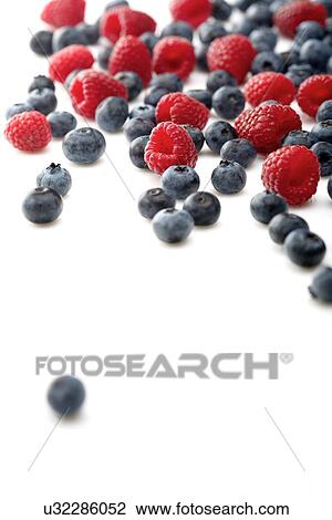 Raspberries and blueberries on white background View Large Photo Image Stock Image - Raspberries and blueberries on white background. Fotosearch