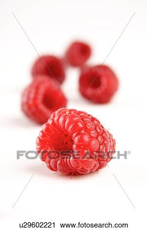 Stock Image - Red raspberries on white background. Fotosearch