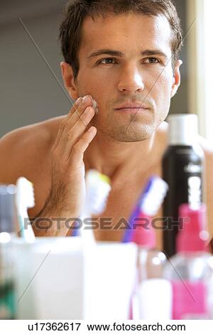 Reflection of young man in mirror applying shaving cream View Large Photo Image Stock Photo - Reflection of young man in mirror applying shaving cream. Fotosearch