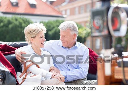 Romantic middle-aged couple sitting in horse cart View Large Photo Image Stock Photo - Romantic middle-aged couple sitting in horse cart. Fotosearch