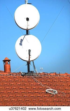 Satellite dishes on a tiled roof View Large Photo Image Stock Image - Satellite dishes on a tiled roof. Fotosearch