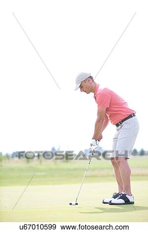 Side view of middle-aged man playing golf at course View Large Photo Image Stock Photo - Side view of middle-aged man playing golf at course. Fotosearch
