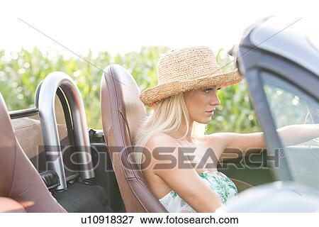 Side view of woman driving convertible outdoors View Large Photo Image Stock Photo - Side view of woman driving convertible outdoors. Fotosearch