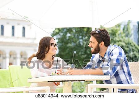 Smiling couple having mojito at sidewalk cafe View Large Photo Image Picture - Smiling couple having mojito at sidewalk cafe. Fotosearch
