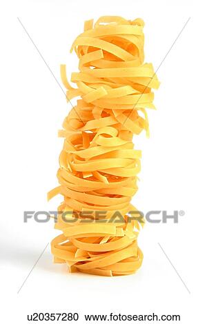 Stock Image - Tagliatelle pasta on white background. Fotosearch