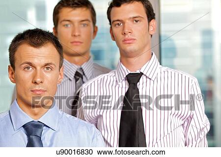 Three businessmen at office, portrait View Large Photo Image Stock Image - Three businessmen at office, portrait. Fotosearch