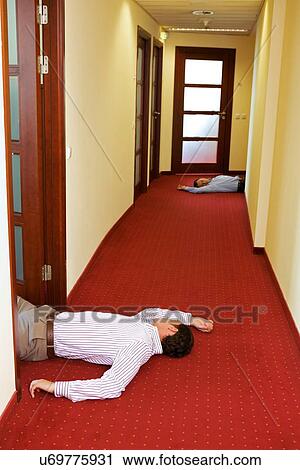 Two businessman lying down in office View Large Photo Image Stock Image - Two businessman lying down in office. Fotosearch