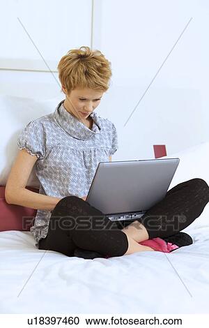 Stock Image - Woman at Home with Laptop Computer. Fotosearch