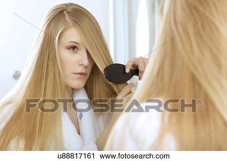 Woman brushing hair View Large Photo Image Stock Image - Woman brushing hair. Fotosearch