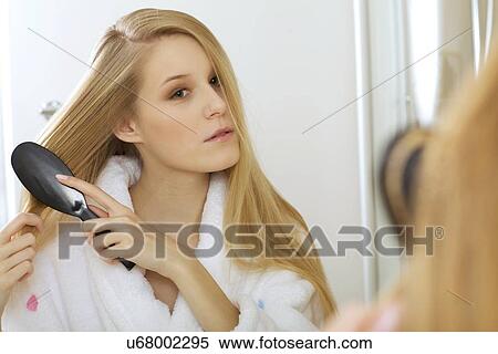 Woman brushing hair View Large Photo Image Stock Photography - Woman brushing hair. Fotosearch