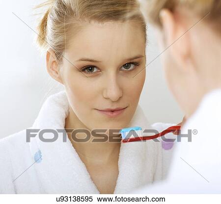 Woman in bathroom brushing teeth View Large Photo Image Stock Photography - Woman in bathroom brushing teeth. Fotosearch