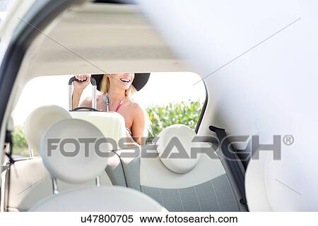 Woman loading luggage in car trunk View Large Photo Image Stock Photography - Woman loading luggage in car trunk. Fotosearch