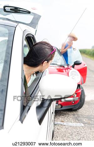 Woman looking at female crashing car on road View Large Photo Image Stock Photo - Woman looking at female crashing car on road. Fotosearch