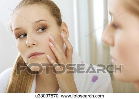 Stock Image - Woman reflaction in mirror. Fotosearch