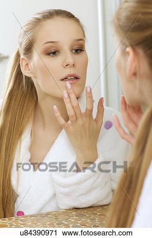 Stock Image - Woman reflection in mirror. Fotosearch