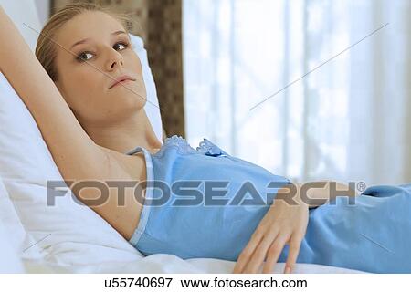 Stock Photo - Woman relaxing in bed. Fotosearch