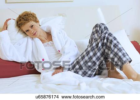 Picture - Woman Relaxing on bed. Fotosearch