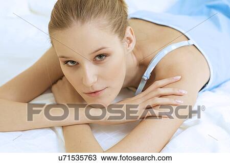 Stock Image - Woman Relaxing on bed. Fotosearch