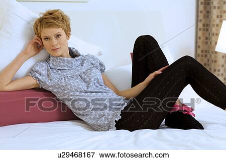 Stock Photo - Woman Relaxing on bed. Fotosearch