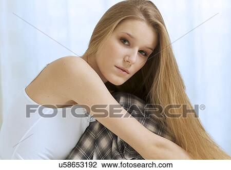 Stock Image - Woman sitting in bed. Fotosearch