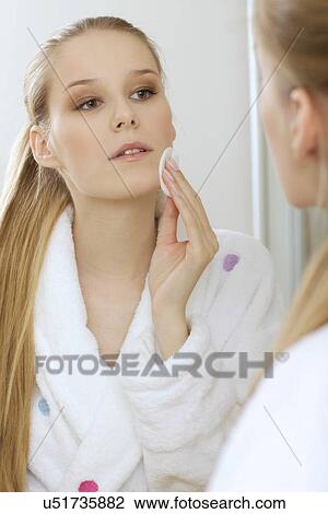 Stock Image - Woman using dabber, portrait, close-up. Fotosearch