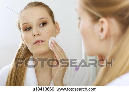 Stock Photograph - Woman using dabber, portrait, close-up. Fotosearch