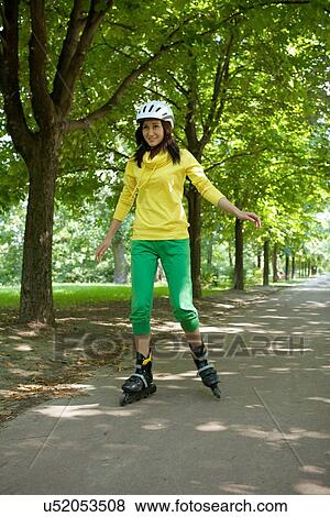 Stock Photo - Yong woman riding roller skate. Fotosearch