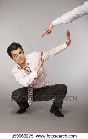 Stock Photography - Young caucasian businessman defeated and beaten up. Fotosearch