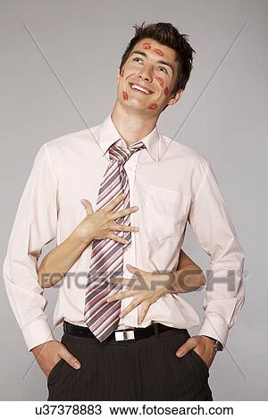 Stock Image - Young caucasian businessman in office romance concept. Fotosearch