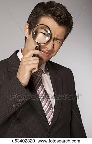 Young caucasian businessman with magnifying glass View Large Photo Image Stock Image - Young caucasian businessman with magnifying glass. Fotosearch